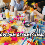 Children sitting at a table filled with colorful craft supplies, painting and creating art projects together, showing how boredom inspires creativity at home.