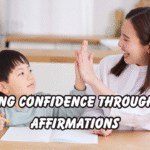 A happy mother and child sitting at a bright kitchen table, smiling and giving a high-five while practicing daily affirmations together. The child holds a pencil and notebook, showing encouragement, learning, and confidence-building through positive parenting.